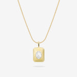 Gold necklace with a round pendant on a white background