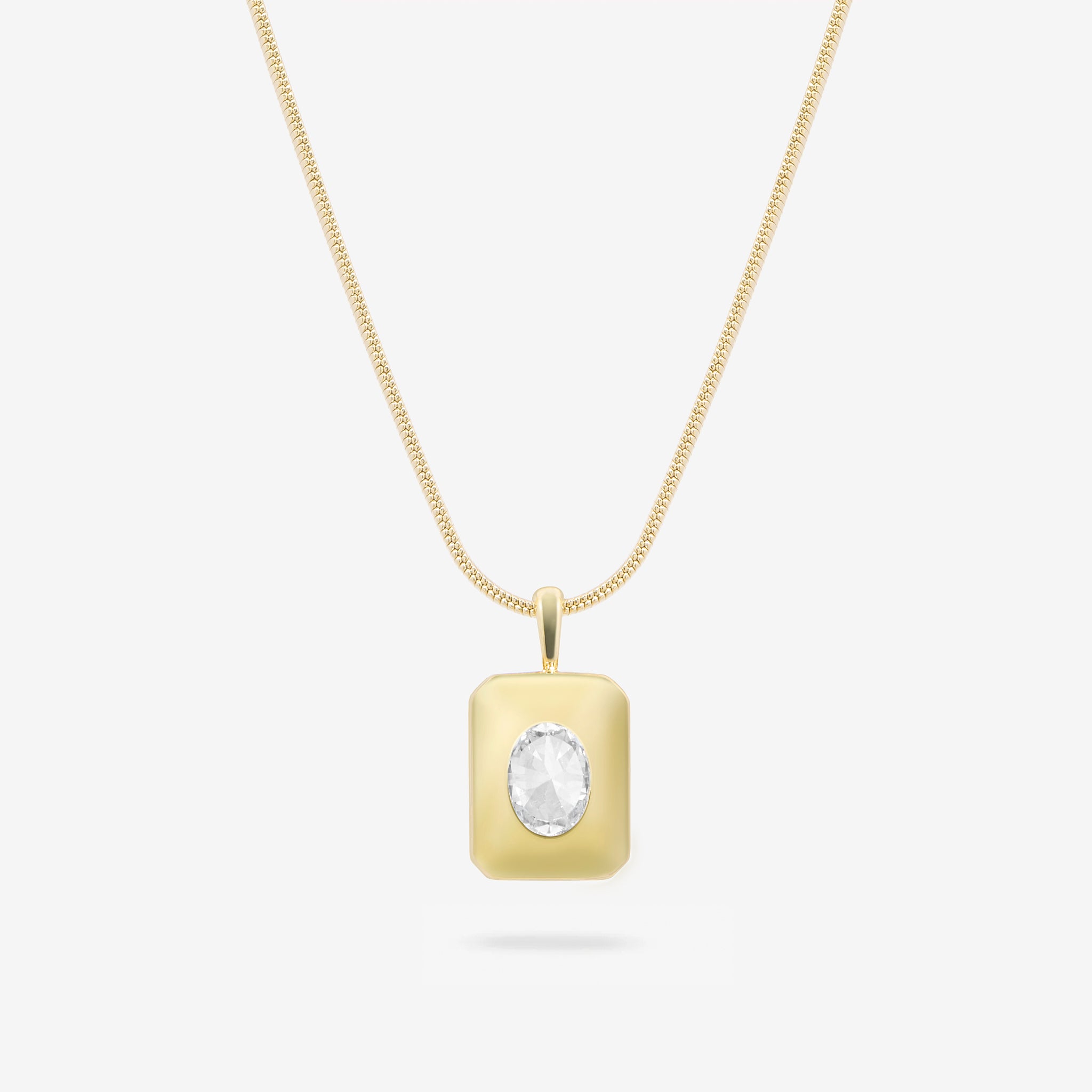 Gold necklace with a round pendant on a white background